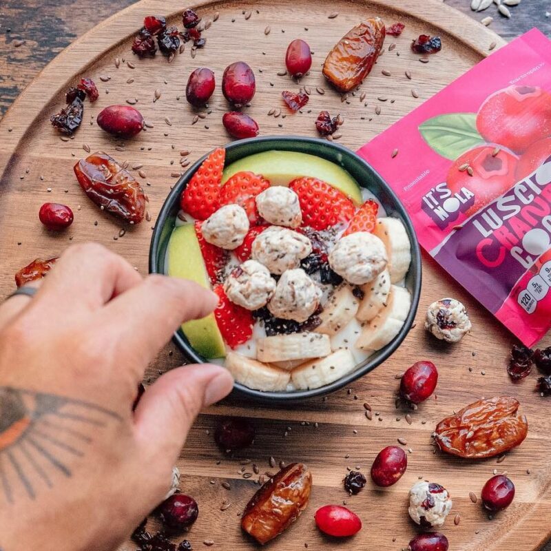 it's nola granola on a serving plate with fruit