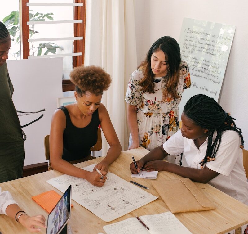 group of female interns working at a desk