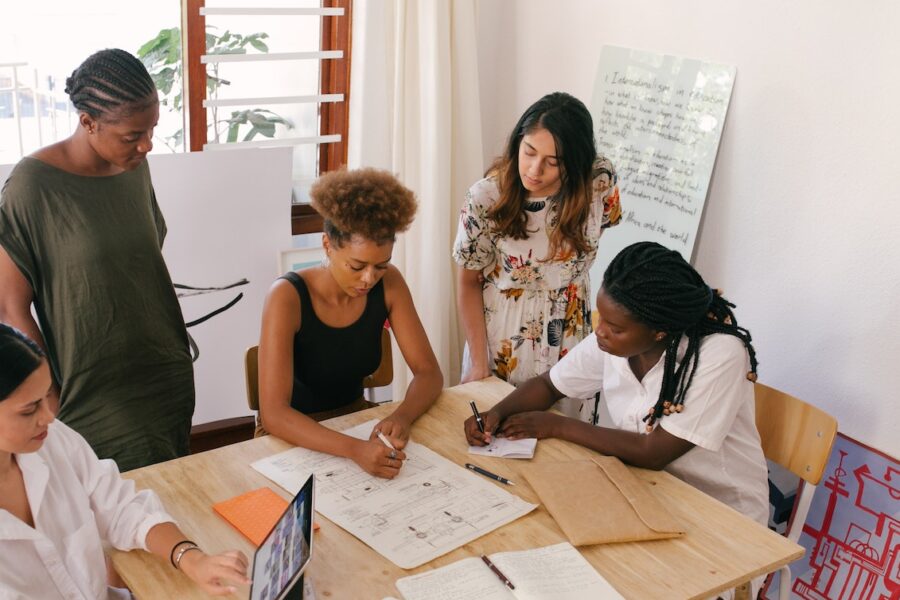 group of female interns working at a desk