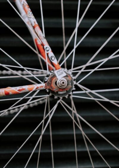 close up photo of a bicycle wheel in front of a black wall