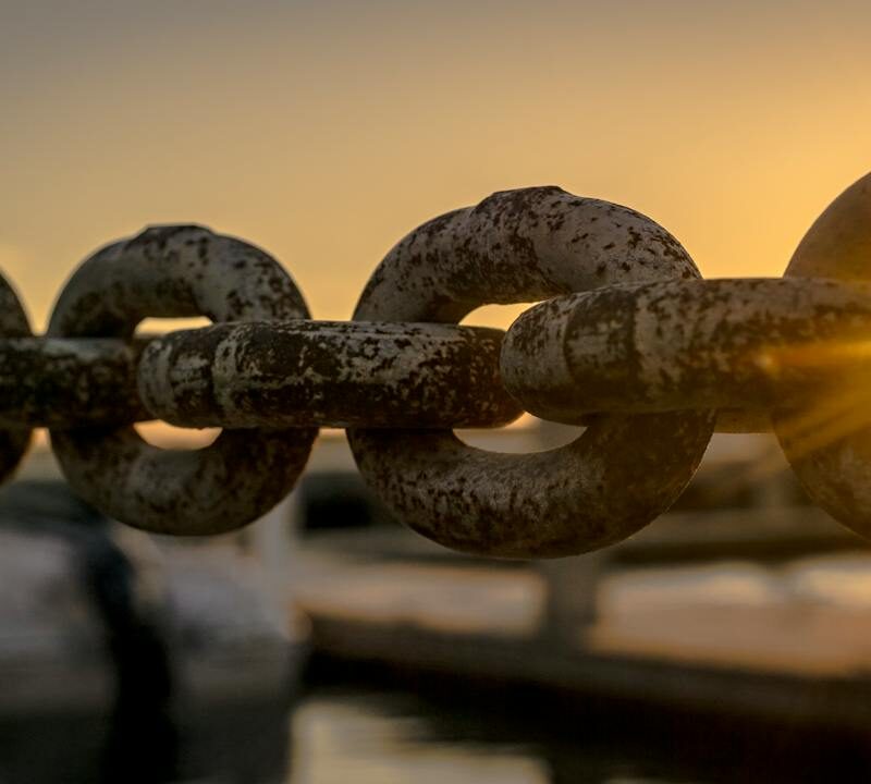 photo of a chain with a sunset
