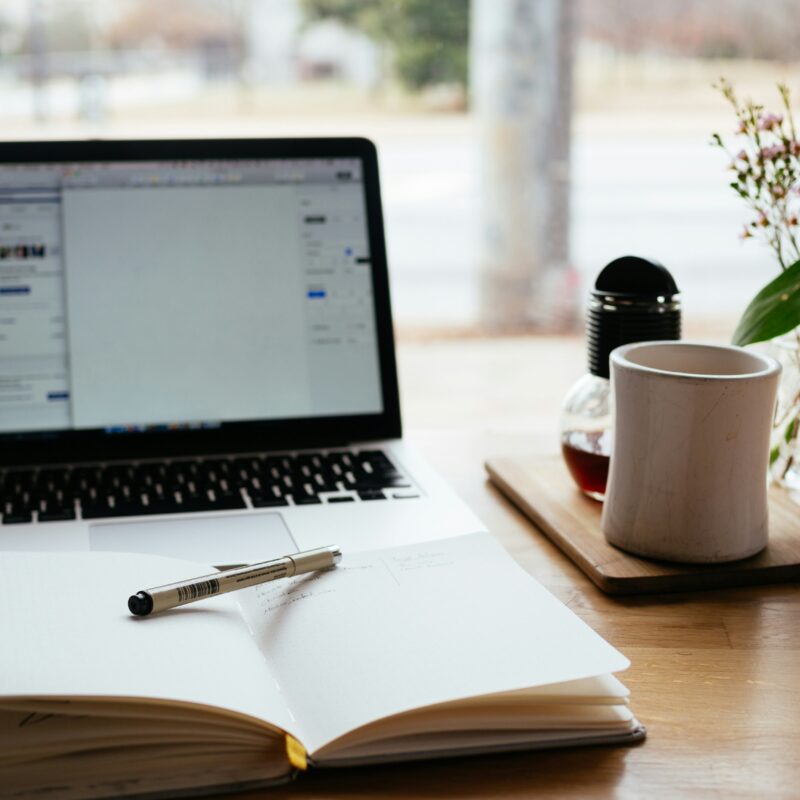 open notebook and pen on a desk