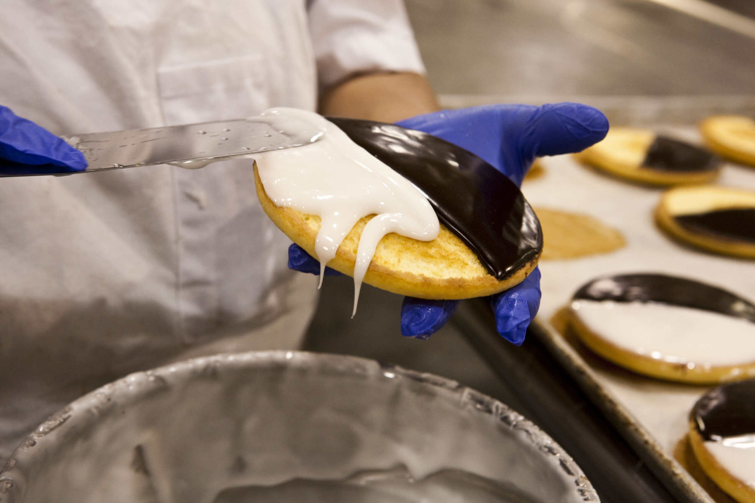 baker covering cookie with frosting